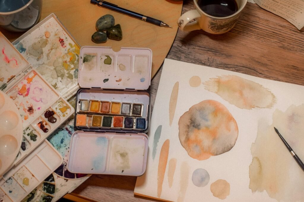 Watercolor paints and brushes on a table
